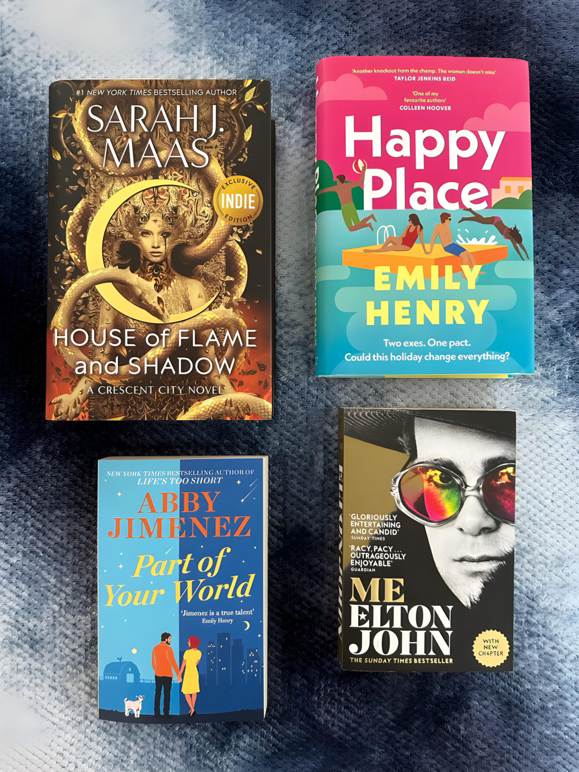Books from my Summer Reading List 2024: House of Flame and Shadow by Sarah J. Maas, Happy Place by Emily Henry, Part of Your World by Abby Jimenez, and Me by Elton John, displayed on a cozy blue background.